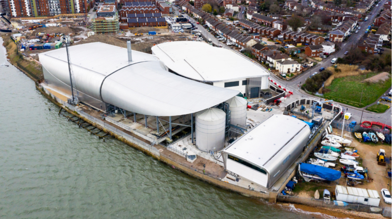 The Woolston WwTW site. Clockwise from the foreground: the sludge processing building, two cylindrical sludge holding tanks, storm tank (beneath canopy), primary clarification building and secondary biological treatment building