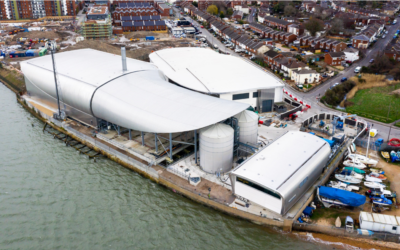 The Woolston WwTW site. Clockwise from the foreground: the sludge processing building, two cylindrical sludge holding tanks, storm tank (beneath canopy), primary clarification building and secondary biological treatment building