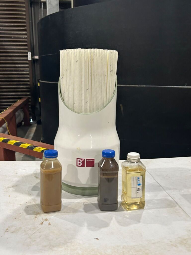 Membrane module cutaway (background) with feed, sludge and permeate samples (foreground)