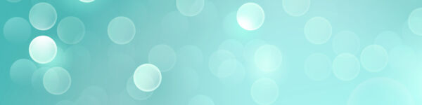 Abstract image of white opaque bubbles on a light teal blue background.