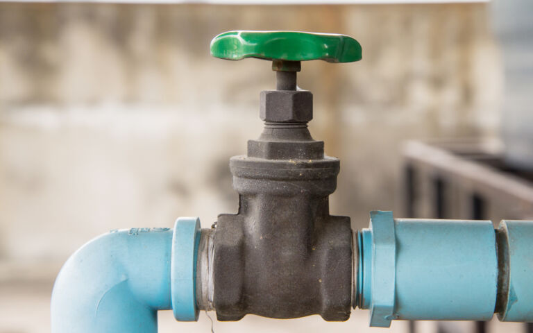 Image of a tap, from the side on. The pipe is covered in blue insultation.