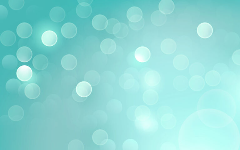 Abstract image of white opaque bubbles on a light teal blue background.