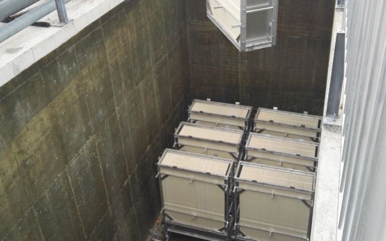 A photo of RisingSun membranes being installed in a tank onsite.