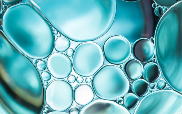 Abstract image of blue bubbles of different sizes in close up.